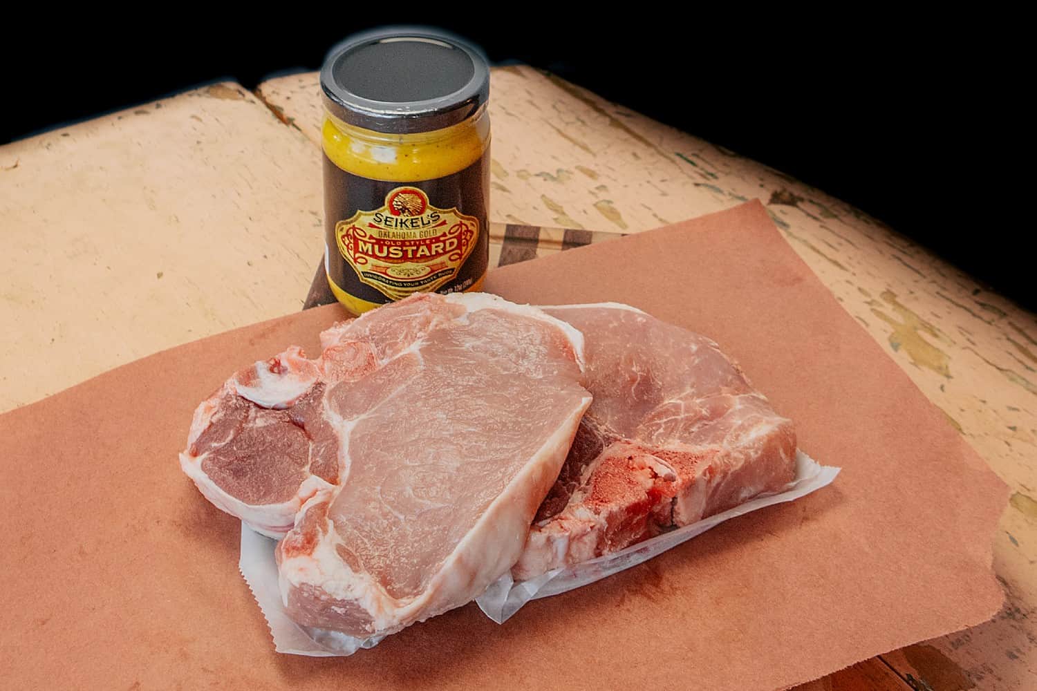 Pork chops, ready to cook, and Seikel's Mustard jar